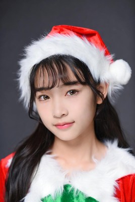 Asian girl in Santa hat and suit