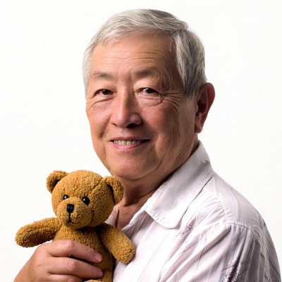 Elderly Asian man holding teddy bear