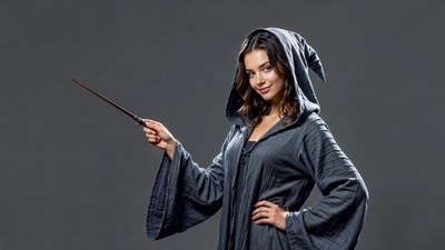 Woman in witch costume holding wand