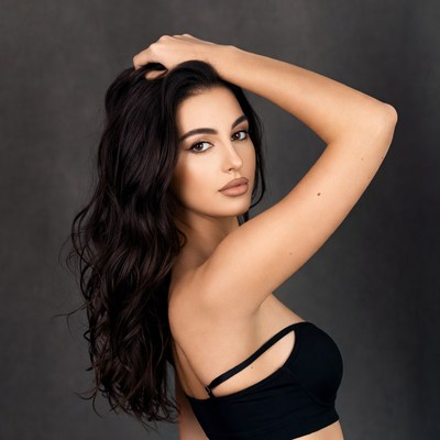 Beautiful woman with hand in long dark hair