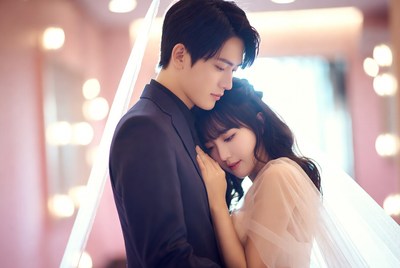 Man embracing woman in wedding attire