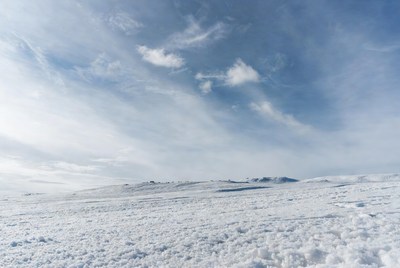 Snowy Hill Under Blue Cloudy Sky