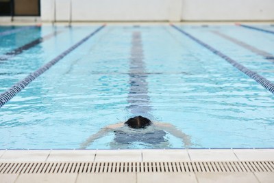 Man swimming freestyle in pool