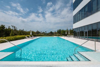 Modern infinity pool by office building