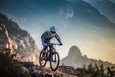 Man mountain biking rocky trail