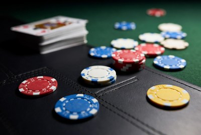 Poker chips and cards on green felt