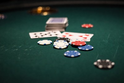 Poker chips and cards on green table