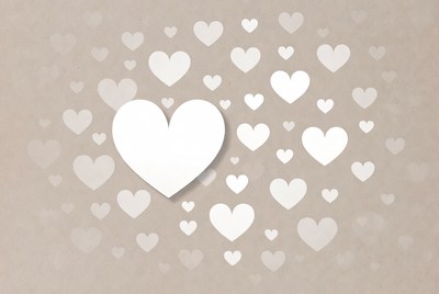 White paper hearts on beige background
