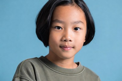 Asian girl smiling on blue background