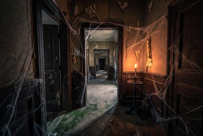 Abandoned Hallway with Cobwebs and Candle