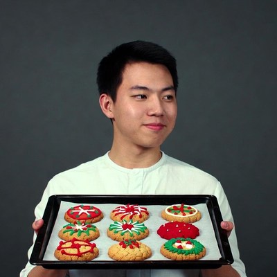 Asian man holding Christmas cookies