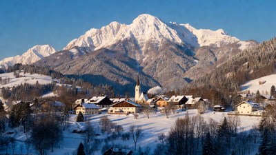 Snowy Alpine Village with Church and Mountains