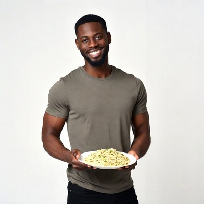 African-American man holding pasta dish