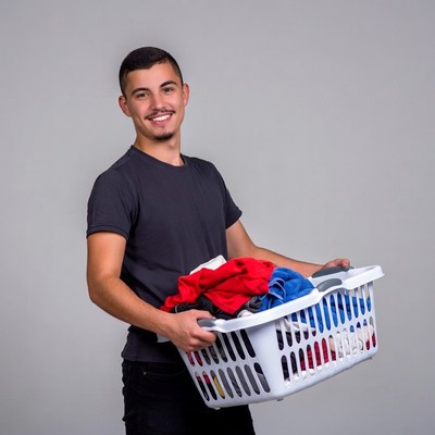 Young man holding laundry basket