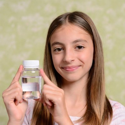 Girl holding clear medicine bottle