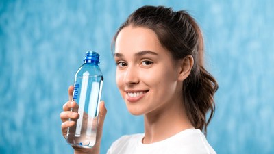 Woman holding blue water bottle
