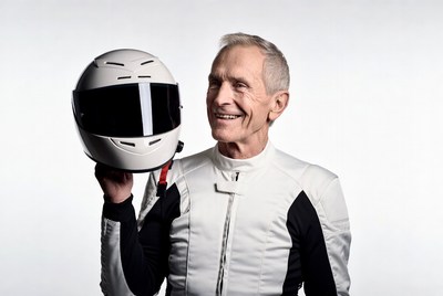 Elderly man holding white helmet