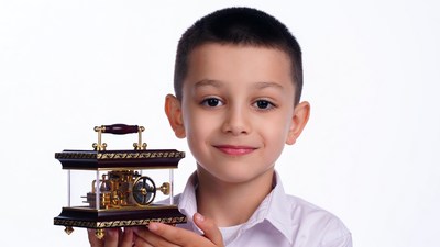 Boy holding ornate clock