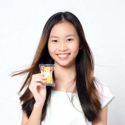 Asian girl holding yellow snack pack