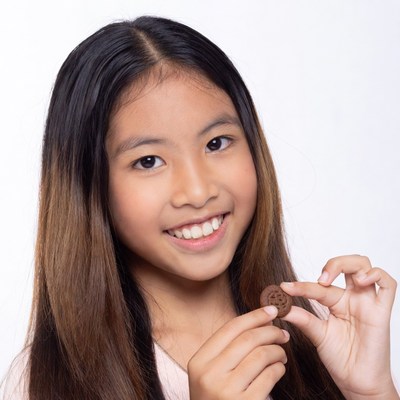 Asian girl holding cookie