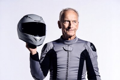 Elderly man holding motorcycle helmet