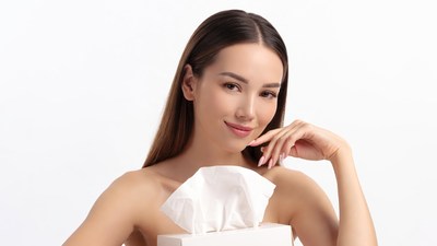 Asian woman holding tissue box