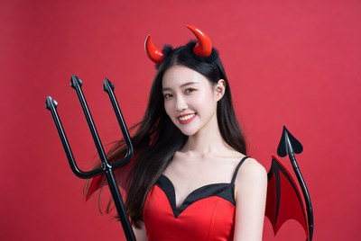 Asian woman in red devil costume