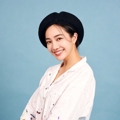 Asian woman in black beret smiling