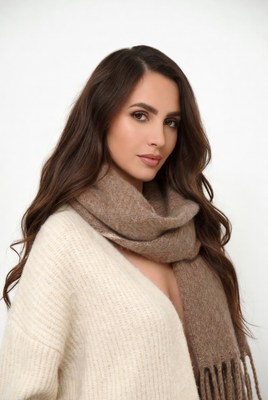Woman in white sweater and brown scarf