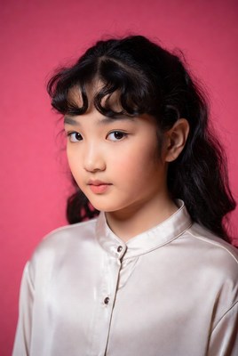 Asian girl with bangs on pink background