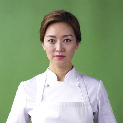 Asian woman chef green background