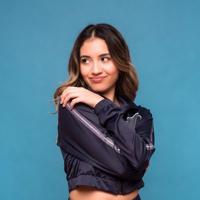 Young woman smirking over shoulder