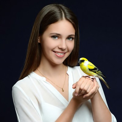 Woman holding yellow canary bird