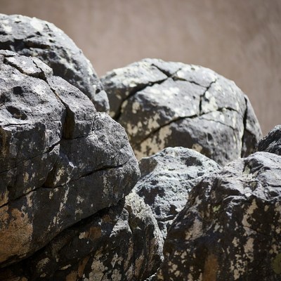 Stacked Gray Rocks on Sandy Ground