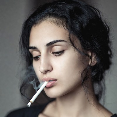 Woman smoking cigarette close-up
