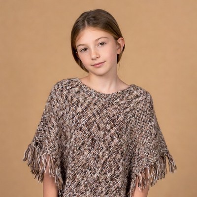 Girl wearing fringed knit poncho