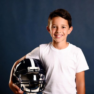 Boy holding football helmet