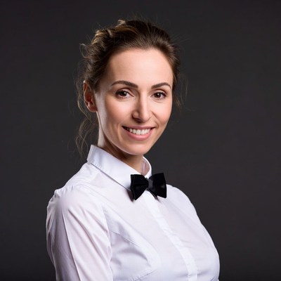 Smiling woman in white shirt bowtie