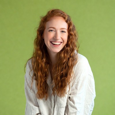 Smiling woman with red curly hair