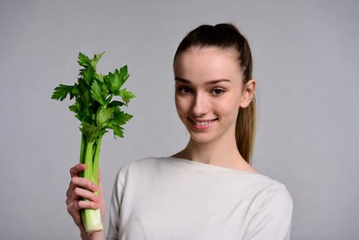 Woman holding fresh celery