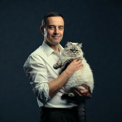 Man holding Persian cat