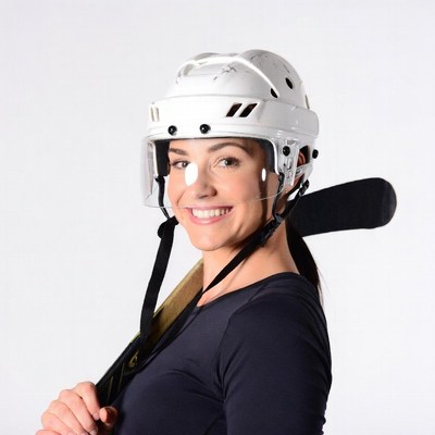 Smiling woman in hockey helmet with stick