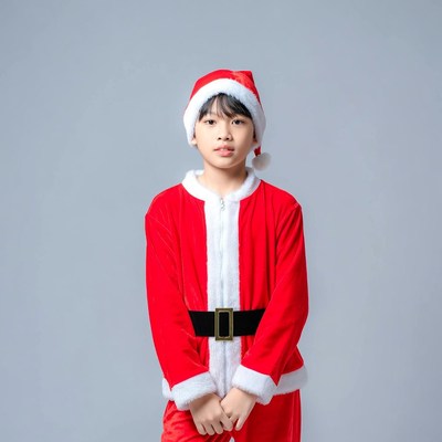 Asian boy in Santa costume