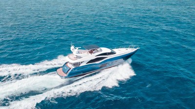 White luxury yacht speeding on ocean