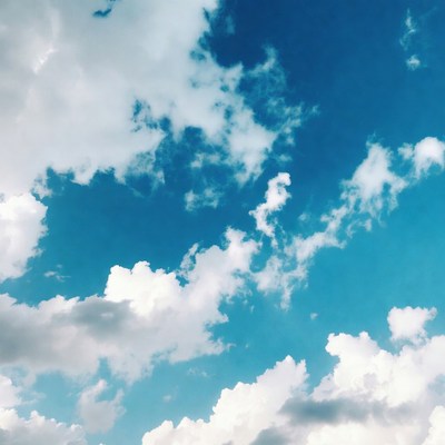Fluffy white clouds in blue sky