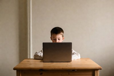Boy using laptop at table