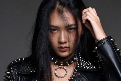 Asian woman in spiked leather jacket