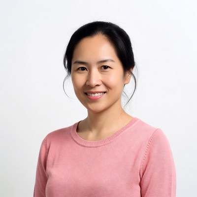 Asian woman smiling in pink sweater