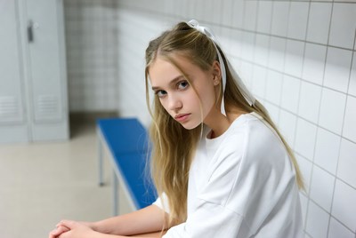Blonde girl sitting on gym bench