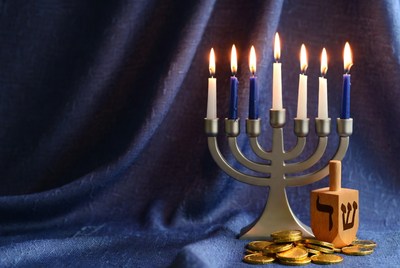 Lit Hanukkah Menorah with Dreidel and Coins